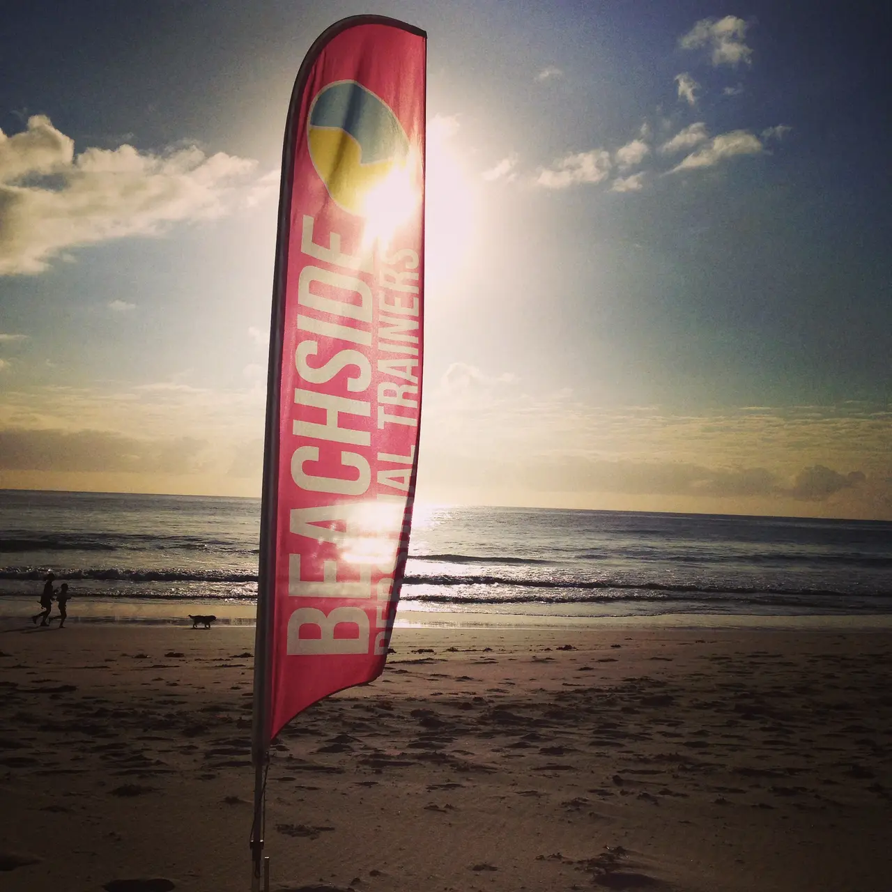 The Beachside flag on the sand at sunrise