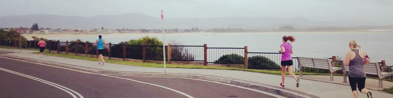 Running along the esplanade by the water