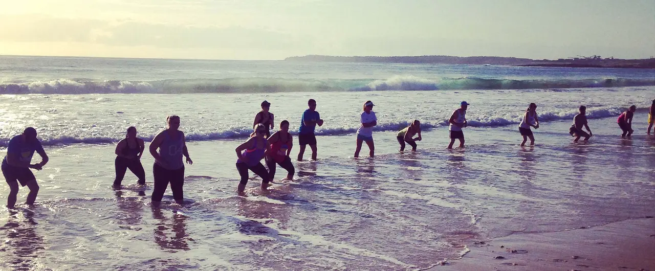 A Beachside group training in the surf